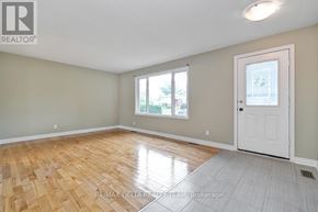 Ottawa apartment for rent - A room with wooden flooring and a white door.