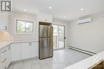 Ottawa apartment for rent - A kitchen with white cabinets and a stainless steel refrigerator.