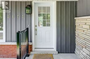 Ottawa apartment for rent - A white door with the number 2173 on the siding above it.