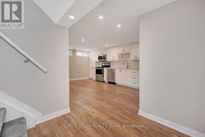 Ottawa apartment for rent - A kitchen with white cabinets and a wooden floor.