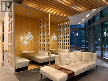 Toronto (Church-Yonge Corridor) condo for rent - A living room with a white couch and a wooden partition.