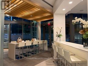 Toronto (Church-Yonge Corridor) condo for rent - A modern dining area with white chairs and a wooden ceiling.