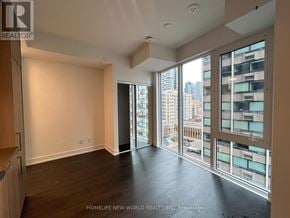 Toronto (Church-Yonge Corridor) condo for rent - A spacious room with a view of the cityscape through large windows.