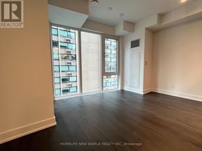 Toronto (Church-Yonge Corridor) condo for rent - A room with a large window and wooden flooring.