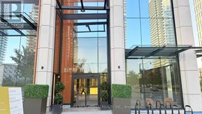 Toronto (Bayview Village) condo for rent - The entrance to a building with a glass door and a sign that reads "HOMELESS NEW WORLD REALTY INC. Brokerage".