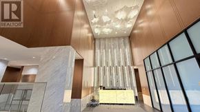 Toronto (Bayview Village) condo for rent - A modern interior space with a wooden ceiling and a chandelier.