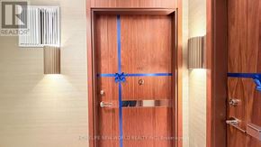 Toronto (Bayview Village) condo for rent - A wooden door with a blue tape across it.