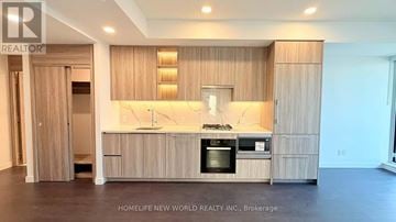 Toronto (Bayview Village) condo for rent - A modern kitchen with wooden cabinets and a central island.