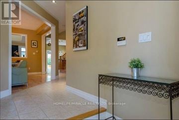 Brampton (Snelgrove) apartment for rent - A living room with a glass table and a plant on it.