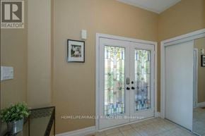 Brampton (Snelgrove) apartment for rent - A glass door with a stained glass window in the middle.