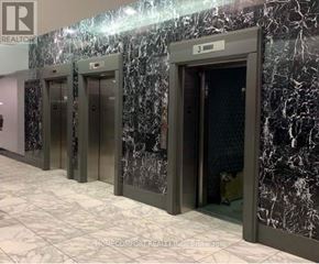 Toronto (Niagara) condo for rent - A row of elevators in a building with marble walls.