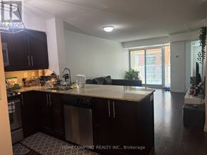 Toronto (Niagara) condo for rent - A kitchen with black cabinets and a white countertop.