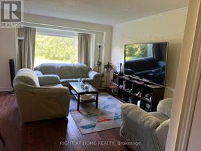 Whitby (Lynde Creek) apartment for rent - A living room with a couch, chair, and television.