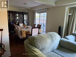 Whitby (Lynde Creek) apartment for rent - A living room with a couch and a dining table.