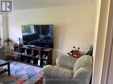 Whitby (Lynde Creek) apartment for rent - A living room with a television and a grey couch.