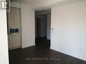 Toronto (Waterfront Communities) condo for rent - A room with a television and a doorway leading to another room.