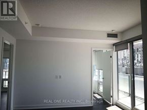 Toronto (Waterfront Communities) condo for rent - A room with a Real One Realty Inc. logo on the wall.