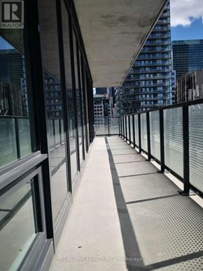 Toronto (Waterfront Communities) condo for rent - A long bridge with a metal railing and glass windows.