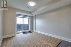 Oakville (Jm Joshua Meadows) condo for rent - A spacious room with a large window and wooden flooring.