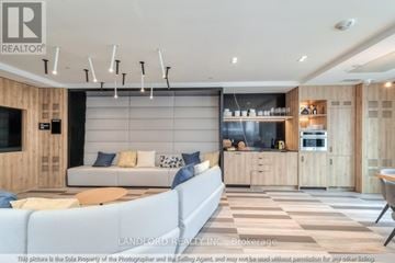 Oakville (Jm Joshua Meadows) condo for rent - A modern living room with a light blue sofa and a television.