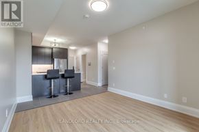 Oakville (Jm Joshua Meadows) condo for rent - A spacious room with a bar area and a refrigerator.