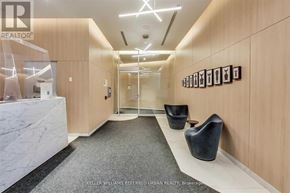Toronto (Niagara) condo for rent - A hallway with a marble counter and chairs on the right side.