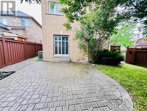 Vaughan (Vellore Village) apartment for rent - A backyard with a brick patio and a tree.