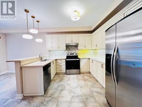 Vaughan (Vellore Village) apartment for rent - A kitchen with a refrigerator, sink, and cabinets.