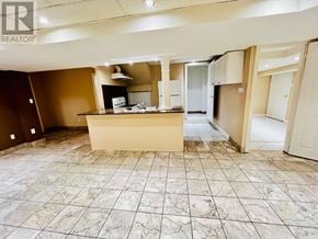 Vaughan (Vellore Village) apartment for rent - A large, empty room with a marble floor and a kitchenette in the middle.