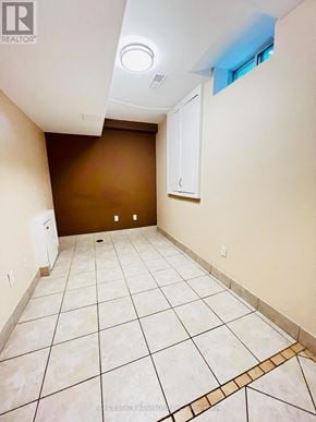 Vaughan (Vellore Village) apartment for rent - A room with brown walls and white tile flooring.