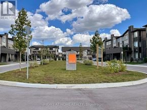 London North (North F) townhouse for rent - A real estate sign in front of a housing development.