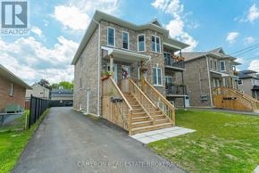 Cornwall triplex for rent - A house with a wooden staircase leading to the front door.