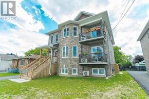Cornwall triplex for rent - A two-story house with a balcony on the second floor.
