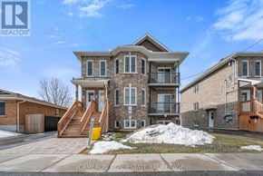 Cornwall triplex for rent - A large house with a stone facade and a balcony is for sale.