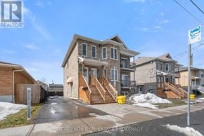Cornwall triplex for rent - A row of houses with a sign that says "Cameron Real Estate Brokerage".