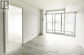 Toronto (Waterfront Communities) condo for rent - A spacious room with a sliding glass door leading to a balcony.