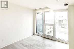 Toronto (Waterfront Communities) condo for rent - A room with a large window and a sliding glass door.