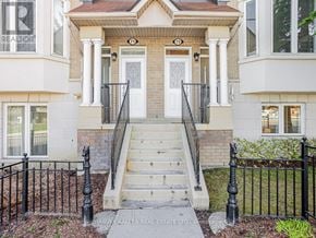 Toronto (Bendale) townhouse for rent - A house with a front porch and a black fence.