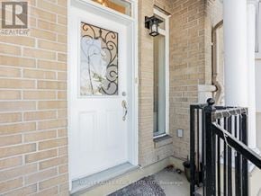 Toronto (Bendale) townhouse for rent - A white door with a glass window and a metal handle.