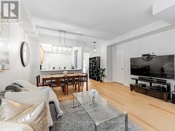 Toronto (Bendale) townhouse for rent - A modern living room with a glass coffee table and a flat screen TV.