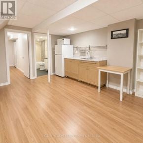 Richmond Hill (North Richvale) townhouse for rent - A kitchen area with a table, chairs, and a refrigerator.