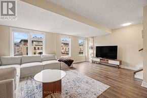Ottawa townhouse for rent - A living room with a white couch, a coffee table, and a television.