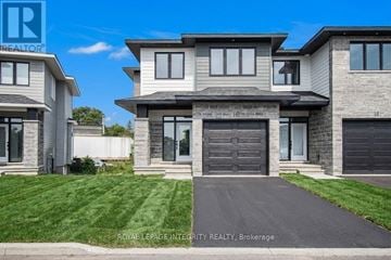 Arnprior townhouse for rent - A modern house with a grey front yard is for sale.