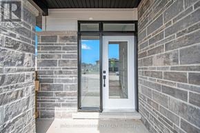 Arnprior townhouse for rent - A door with a glass window is set in a stone wall.