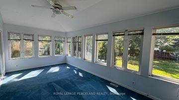 Toronto apartment for rent - A spacious room with a ceiling fan and large windows.