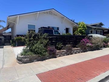 San Diego apartment for rent - A white house with a black truck parked in front.