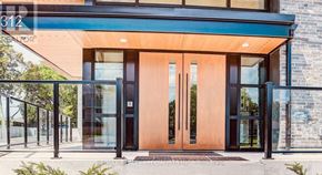 Waterloo condo for rent - The front of a building with a glass door and a sign that reads "312".