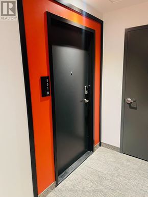 Waterloo condo for rent - A black door with a silver handle and a sign on the wall above it.