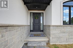 Thames Centre apartment for rent - A house entrance with a black door and a wreath on it.