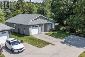 Huntsville (Chaffey) house for rent - A white car is parked in front of a house with a garage.